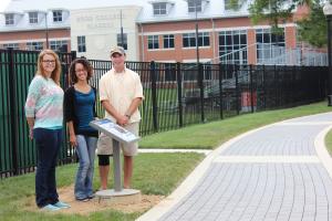 students stand along permeable paver walkway on campus