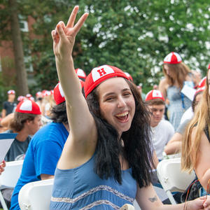 A Hood student shows a peace sign during the Convocation ceremony