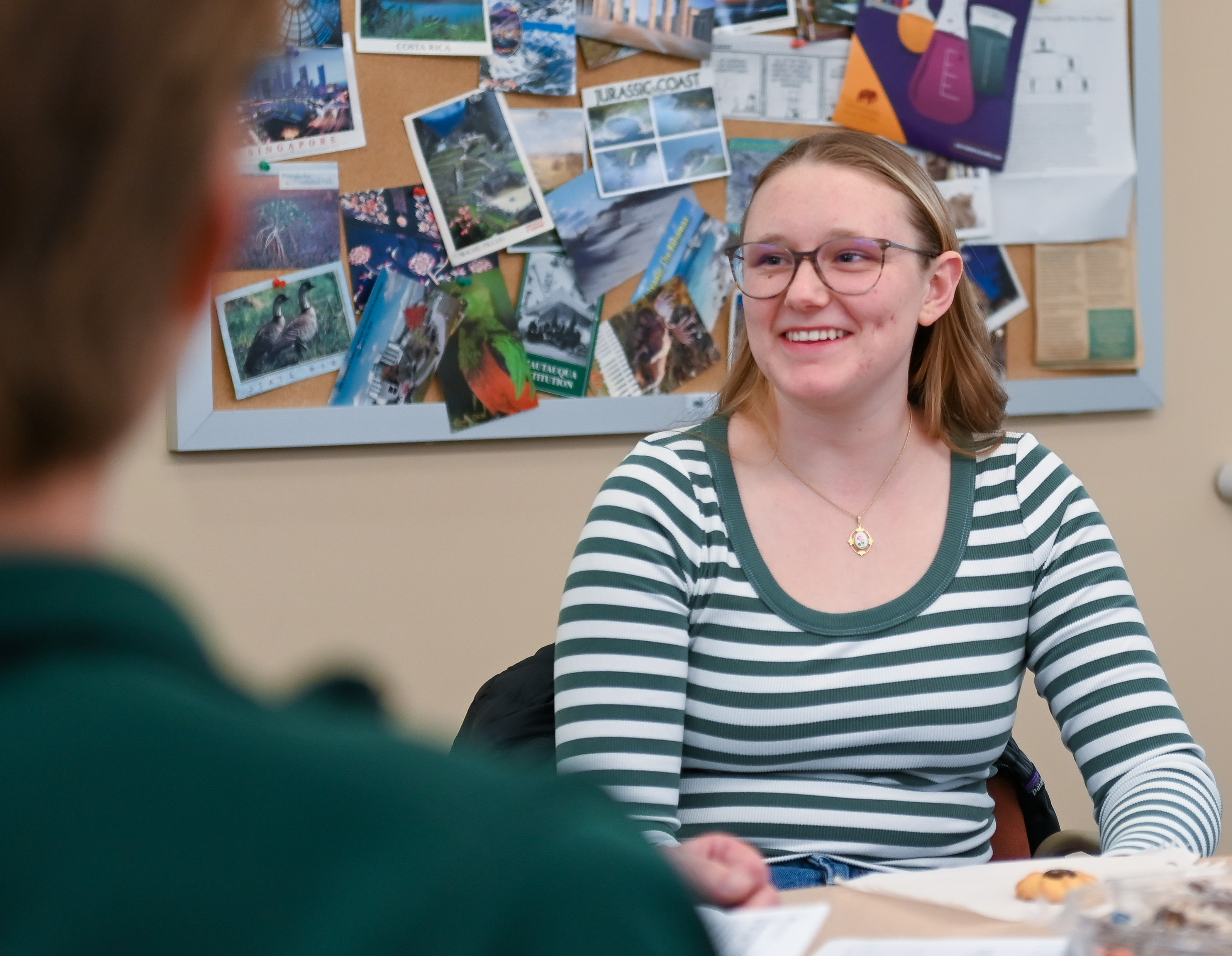 Member of the BlazerBloom team sits at a table with her colleagues, laughing