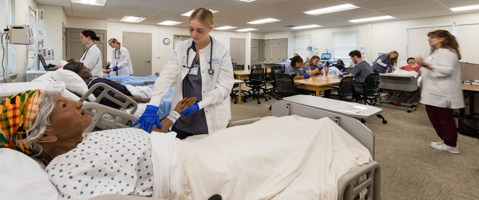 hood college nursing students work with SIM dolls