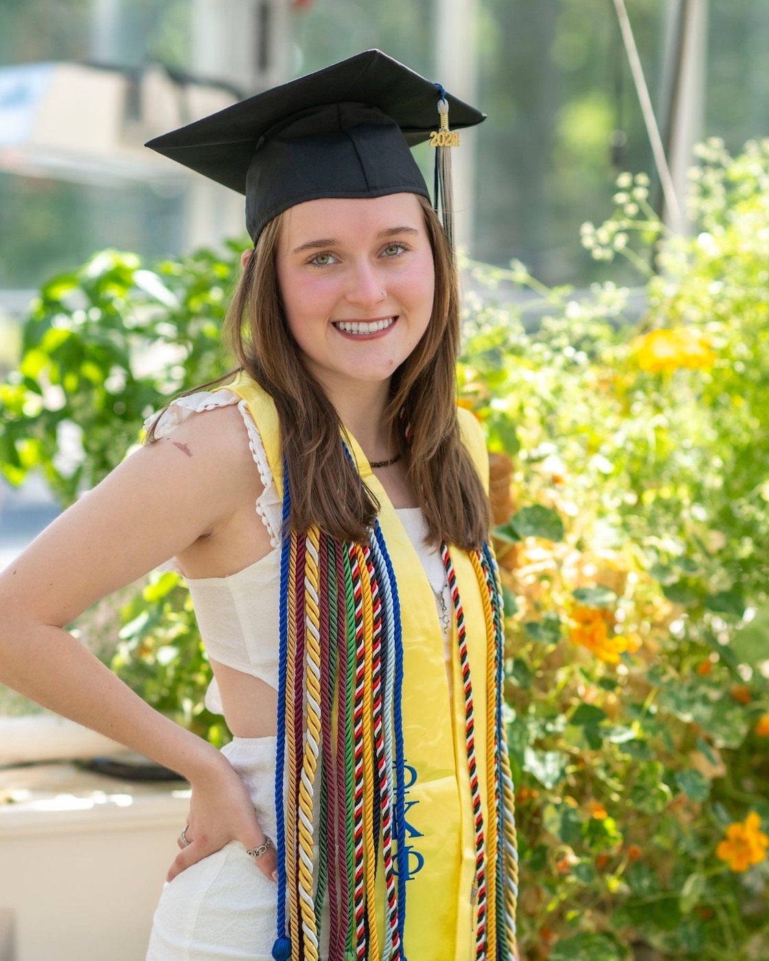 A photo of Riley Larkin Fitz wearing a cap and cords.