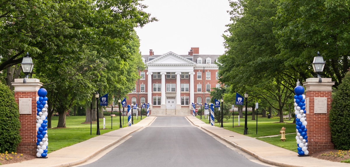 Photo of Hood College's front entrance with Commencement decor