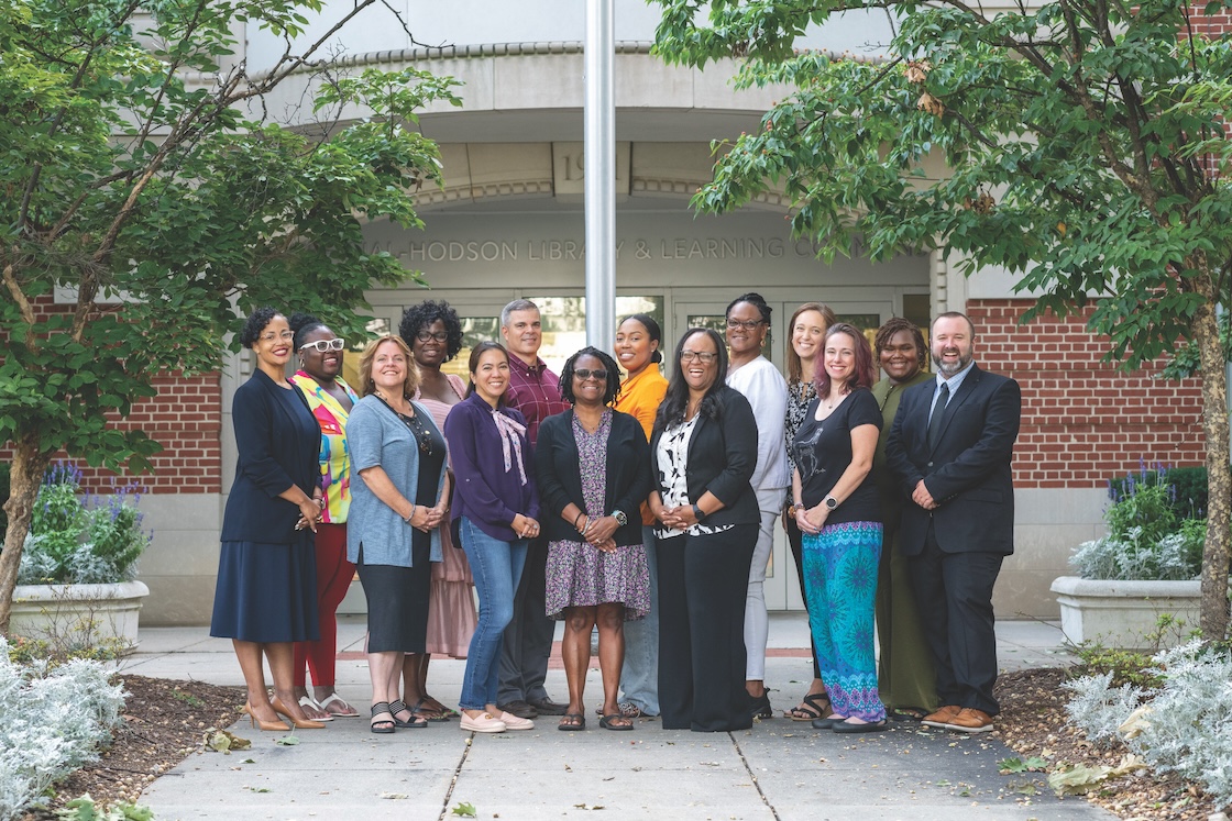 Hood's ninth doctoral cohort standing outside the library.