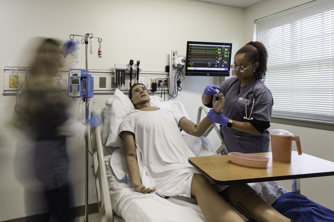 Nursing students working in the sim lab