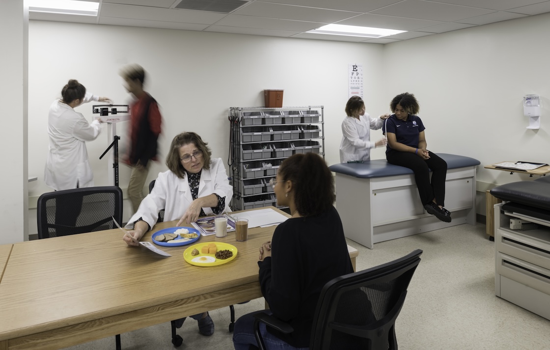 Nutrition students practicing with patients.