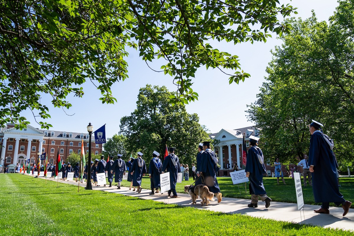 Hood College students process through the residential quadrangle during Commencement