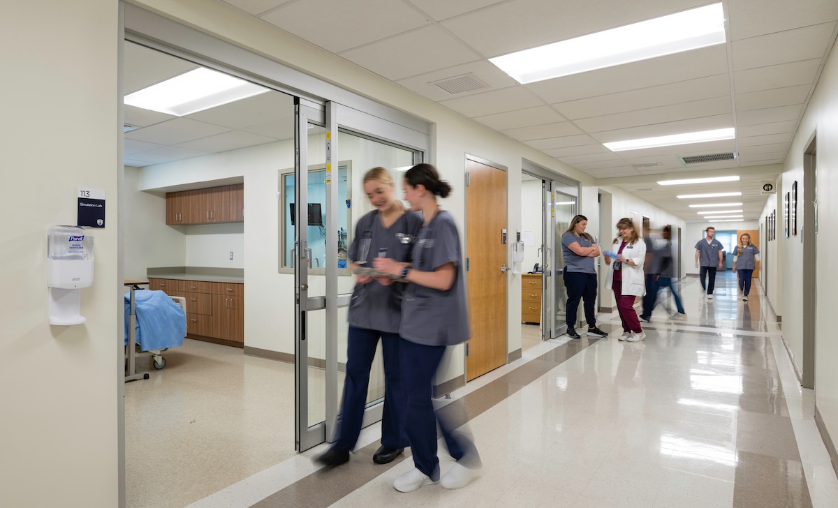 Hood College Nursing students work together on the floor during a clinical simulation in the Ruth Whitaker Holmes School of Behavioral and Health Sciences