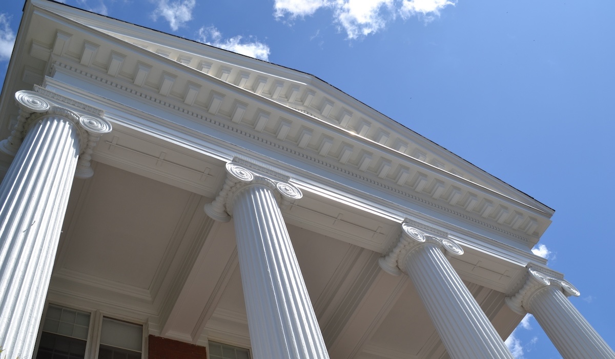 A close-up of Alumnae Hall's ionic columns representing Hope, Opportunity, Obligation and Democracy