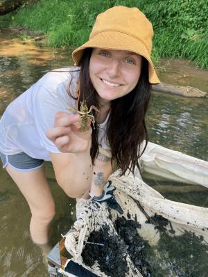 Higgins in the field holding crayfish