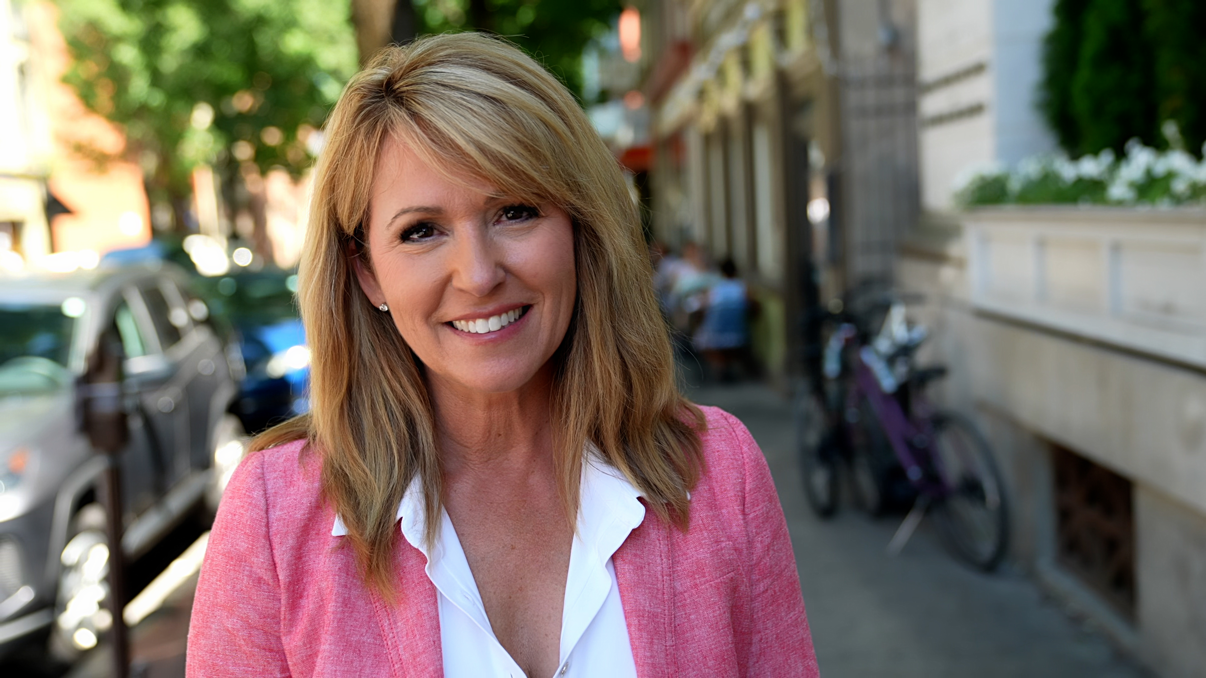 Kelly Schulz stands facing the camera in downtown Frederick