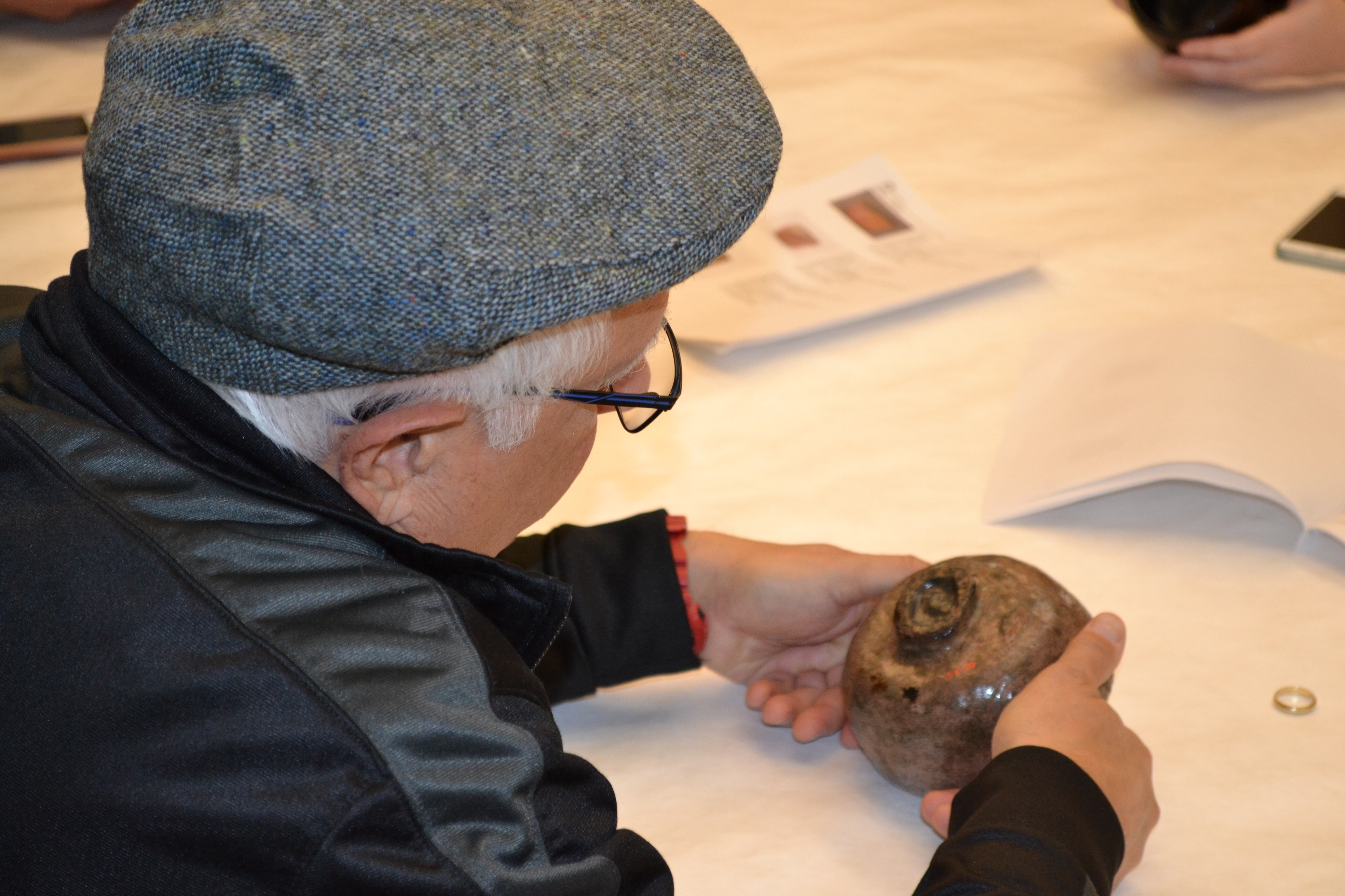 A student studies a tea bowl