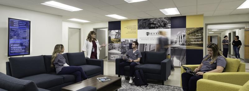 Students and faculty gather in the lobby of the Ruth Whitaker Holmes School of Behavioral Health Sciences, home of Hood College's nursing department