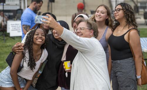 President Debbie Ricker, Ph.D., takes a selfie with Hood College students during Spring Fest 