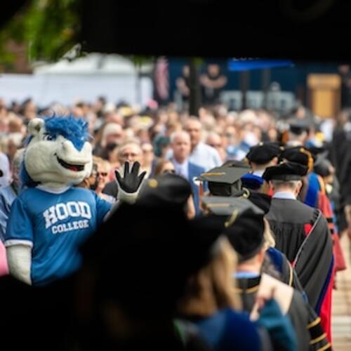 Hood College Mascot Blaze the Horse waves at new graduates