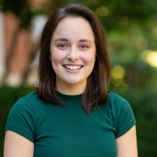 photo of a woman with shoulder length brown hair and a green top