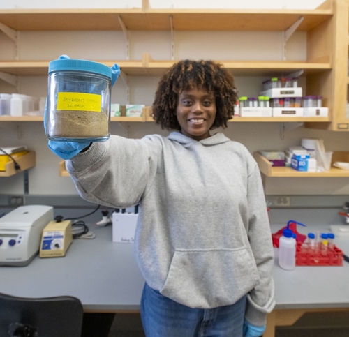Elisha Kabongo '27 displays soybean waste.