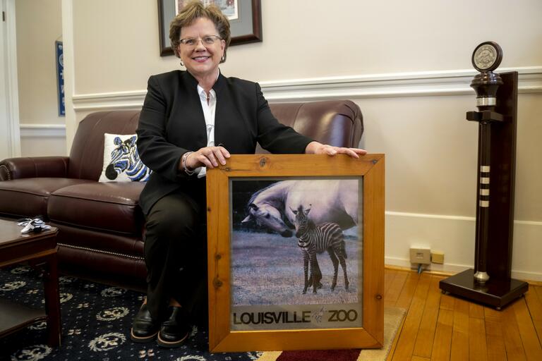 President Debbie Ricker, Ph.D., with a poster from the Lousiville Zoo