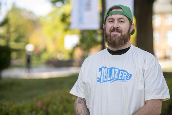 Derek Miller standing on the Quad.