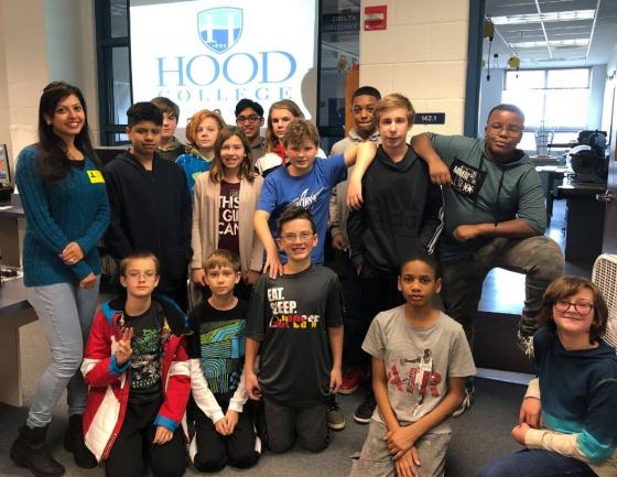 Group of middle school students participating in the Hour of Code event with current Hood graduate student Arundhati Naikavde.