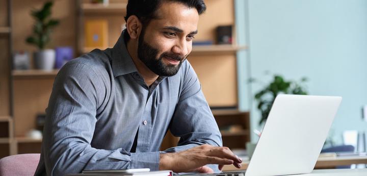 Photo of a man working at a laptop