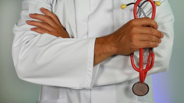 Doctor arms, holding stethoscope