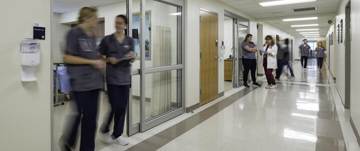 Nursing students walking past the simulation labs.