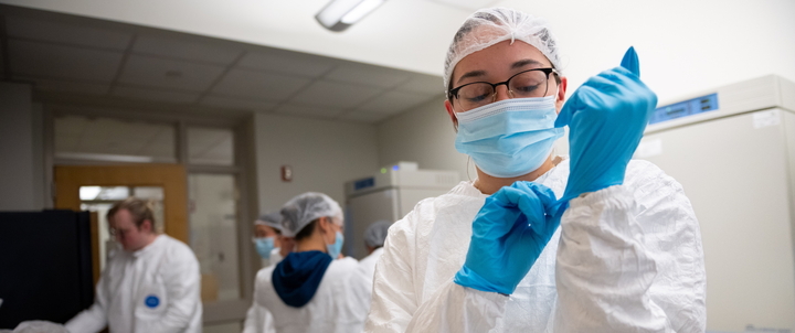 A Hood student wearing PPE in a lab on campus.