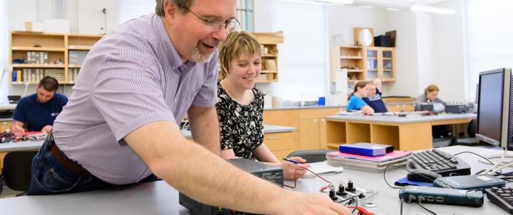 Physics professor with student