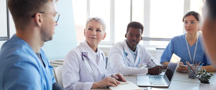 A group of nursing doctoral students sitting at a table studying